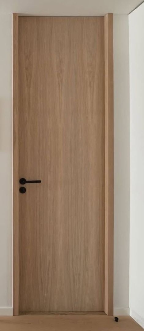 Closed oak door with black handle