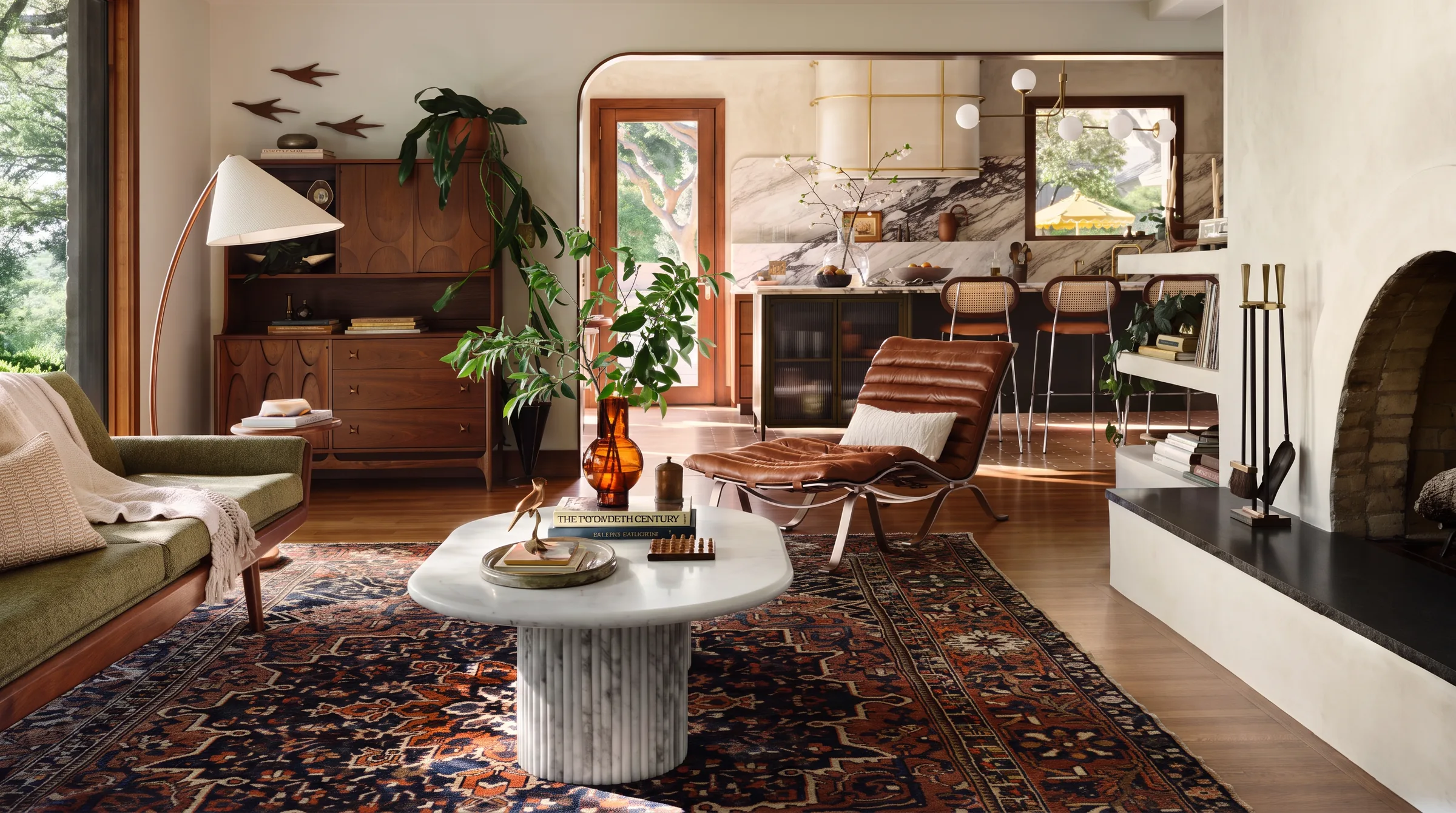 A mid-century modern living room with a walnut sideboard, a green wood-framed sofa, a leather sling lounge chair and a round marble coffee table