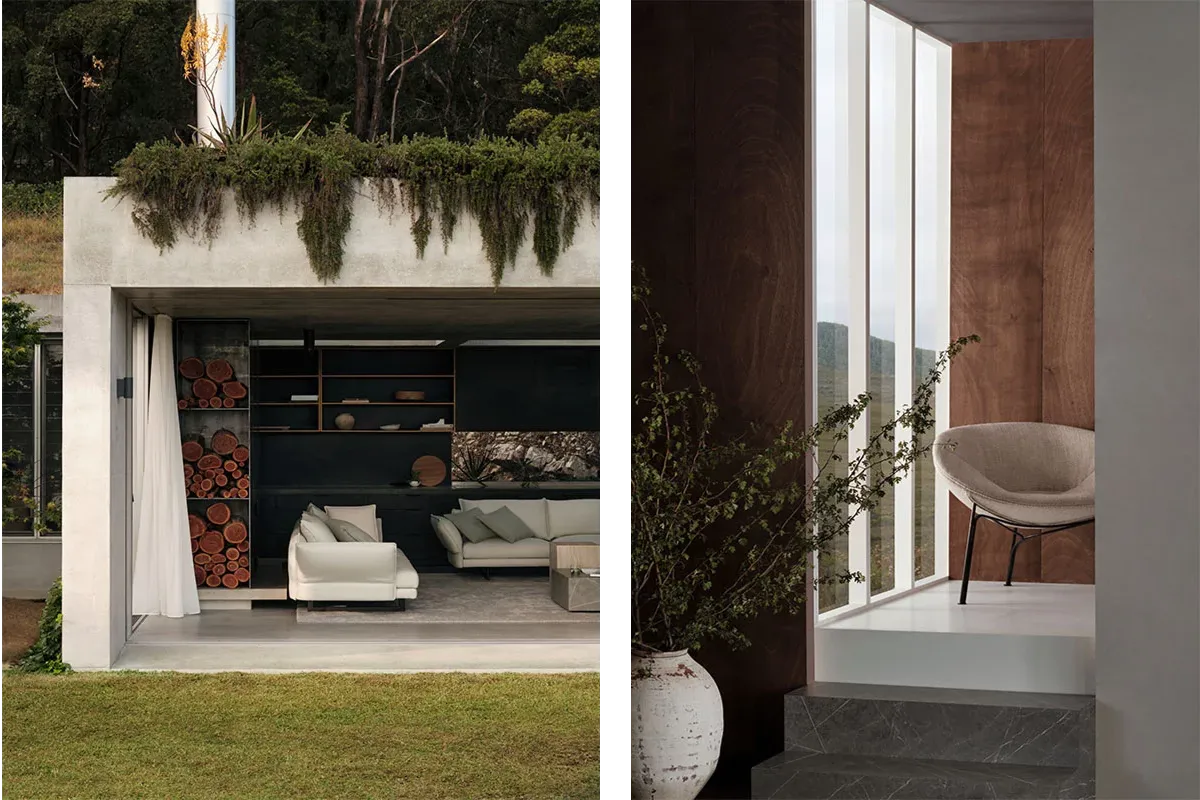 A concrete garden pavilion with planting along its roof and stacked firewood in a shelving unit, next to a timber lined room with a branch in a stone vase