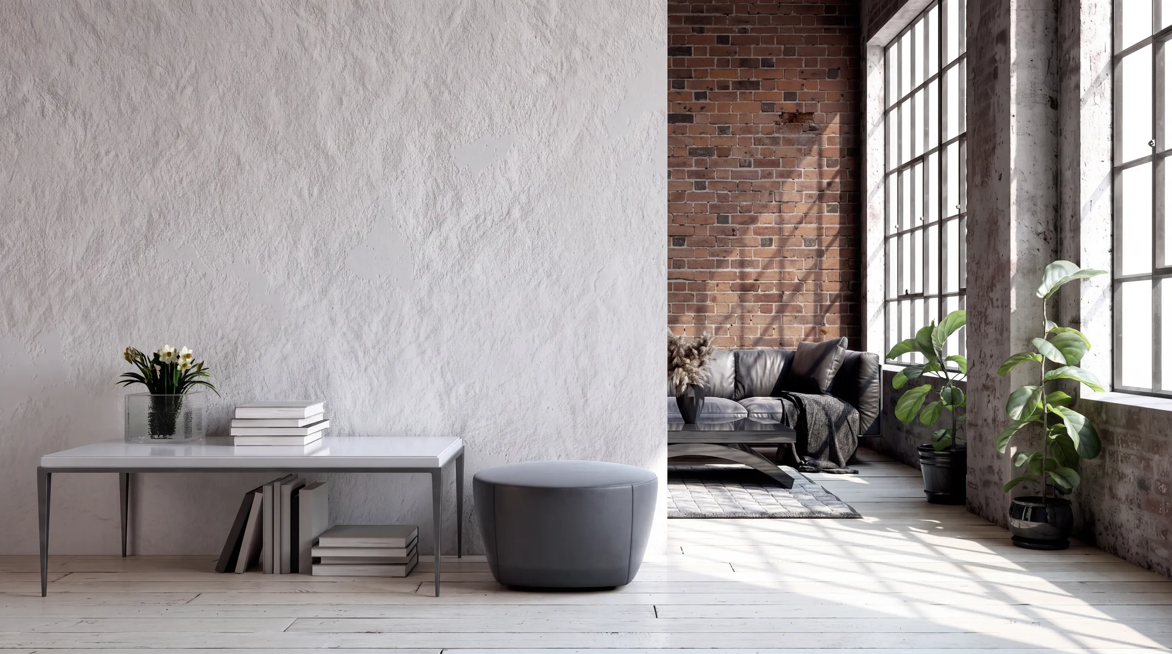 Living space with a textured white plaster wall, an exposed brick wall behind a black leather sofa, potted plants and a pale wood floor.