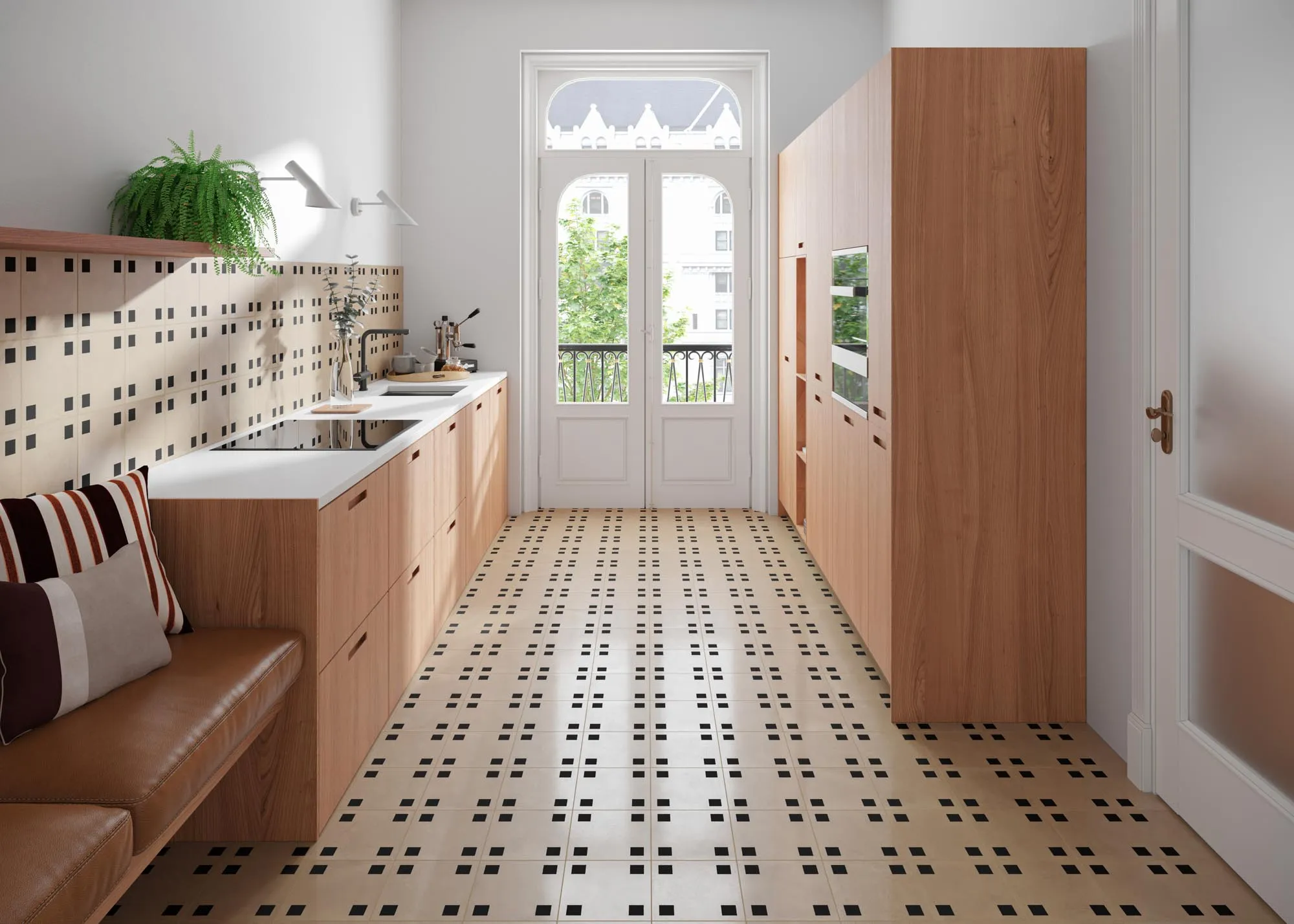 Narrow kitchen with a built-in leather bench along one wall, patterned tile floor, wooden cabinets and a glazed balcony door.