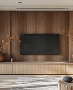 Modern floating TV unit with matte timber fronts, the screen wall mounted on a slatted walnut panel in a living room