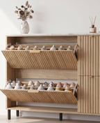 Fluted oak tilt-out shoe cabinet with both flaps open and full of shoes, a column of doors at the side