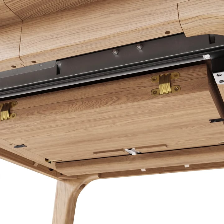 Underside of an oak extending table: a black bolted metal slide, the folded leaf on brass hinges and a tapered leg