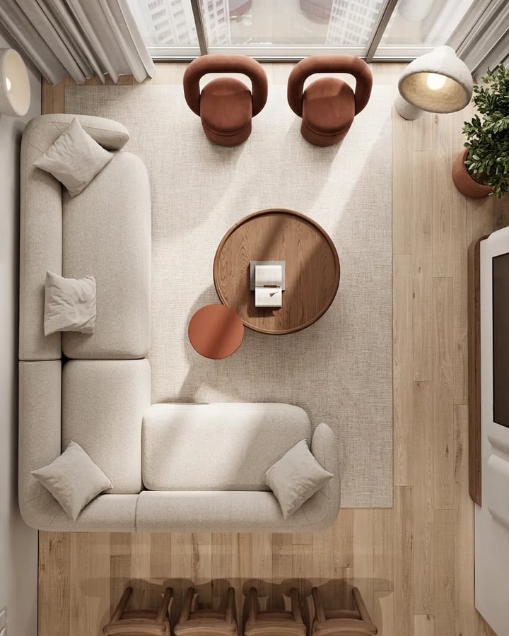 Living room from above: beige corner sofa, round walnut coffee table on a large rug, two armchairs and a clear path to the TV
