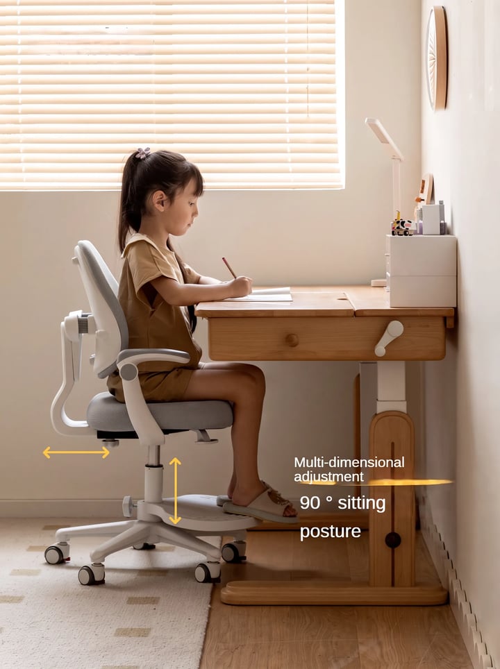 Girl on an ergonomic chair with a footrest, knees at 90 degrees, writing at a height-adjustable wooden study desk
